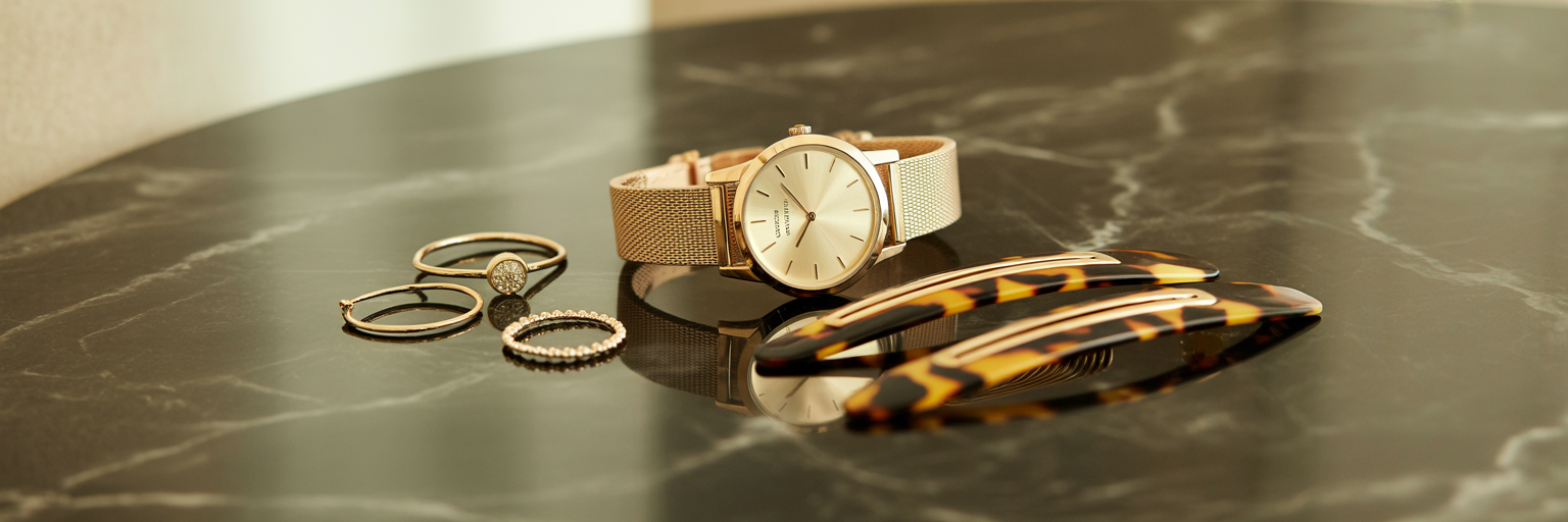 Flat lay of coordinated luxury accessories.